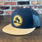 Wrath and Grace Logo Flatbill Snapback in Navy and Cork with Gold Patch