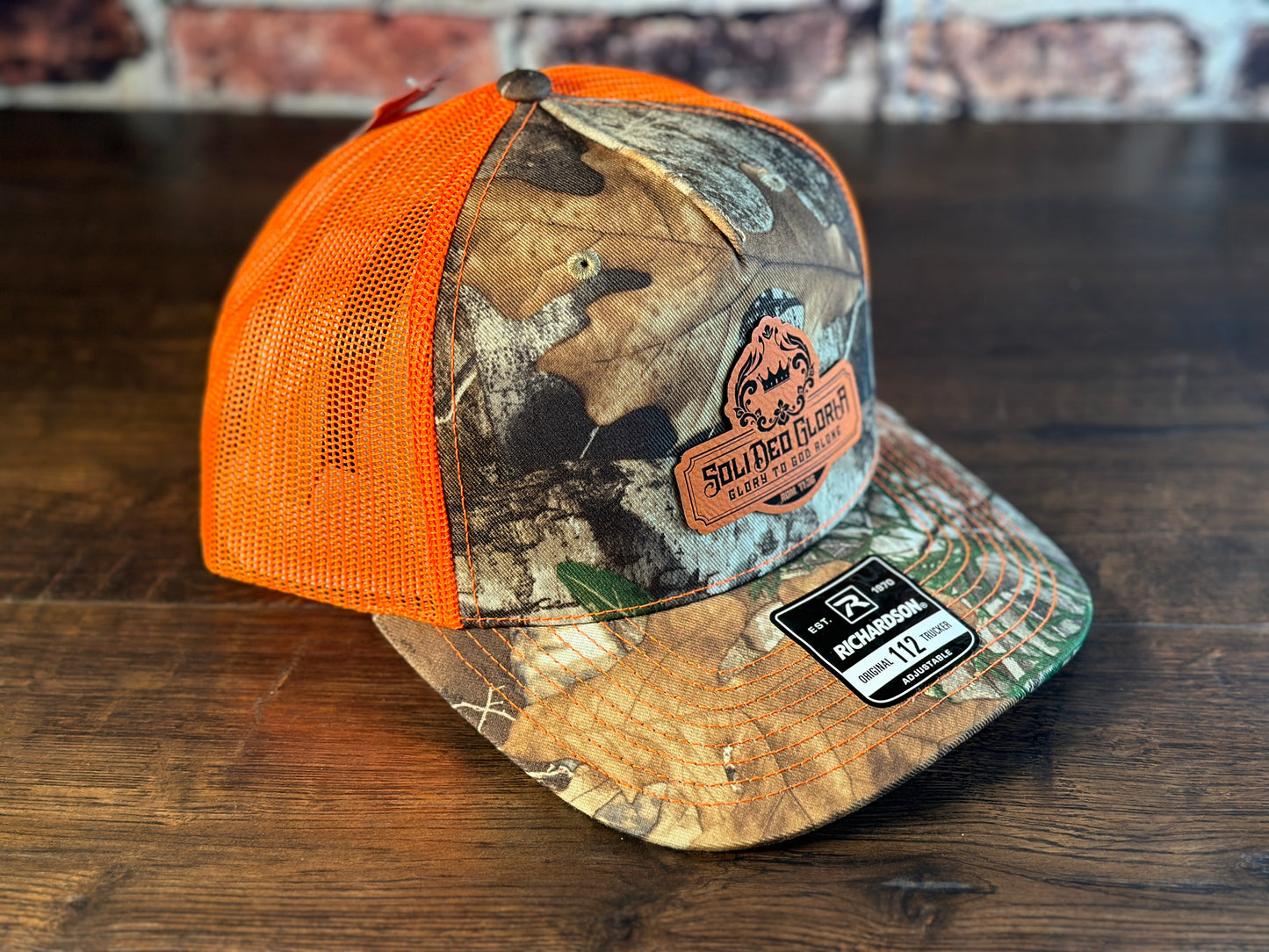 SDG Realtree Edge and Blaze Orange Trucker Hat with Orange Patch